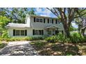 Charming two-story home with a combination of white brick and wood siding, and mature landscaping at 6301 13Th N Ave, St Petersburg, FL 33710