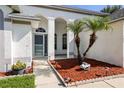 Charming front entrance with decorative landscaping and walkway to the front door at 6318 Ashfield Pl, Wesley Chapel, FL 33545
