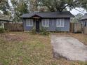 Charming home with a small front yard and driveway; wood fence visible on adjacent property at 6515 30Th N St, St Petersburg, FL 33702