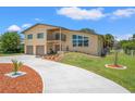 Charming two-story home with a balcony, two-car garage, and a meticulously maintained front yard at 6780 Greenbrier Dr, Seminole, FL 33777