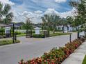 Gated community entrance with manicured landscaping and neighborhood homes at 8119 Trimbelle Ter, Parrish, FL 34219