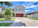 Charming two-story home boasts a brick driveway and a well-maintained landscaped yard at 828 Terra Vista St, Brandon, FL 33511