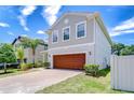 Charming two-story home boasts a brick driveway and a well-maintained landscaped yard at 828 Terra Vista St, Brandon, FL 33511