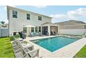 Backyard oasis featuring a sparkling pool, comfortable lounge chairs, and a screened-in patio at 8305 Praise Dr, Tampa, FL 33625
