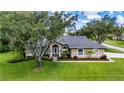Well maintained single story home with mature trees, landscaping, and a manicured lawn at 8901 Eagle Watch Dr, Riverview, FL 33578