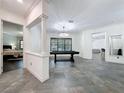 Bright and airy game room with a chandelier, tile floor and pool table for entertainment at 9808 Milano Dr, Trinity, FL 34655
