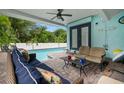Inviting pool patio with comfortable seating, string lights, and a view of the private pool at 14030 79Th Ave, Seminole, FL 33776