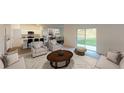 Spacious living room with neutral decor, plush seating, and sliding glass doors leading to the outdoors at 14710 Italy Ave, Dade City, FL 33523
