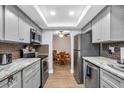 Remodeled kitchen with stainless steel appliances, granite counters, and updated cabinets at 1485 Lakeview Rd # 2, Clearwater, FL 33756