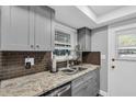 This updated kitchen has granite countertops, gray cabinets and stainless steel appliances at 1485 Lakeview Rd # 2, Clearwater, FL 33756