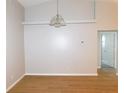 Dining room with wood flooring, neutral walls, and modern light fixture at 2114 Intervista Ln, Valrico, FL 33594