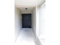 Inviting entryway featuring a modern black front door with sidelight, creating a welcoming entrance at 2114 Intervista Ln, Valrico, FL 33594