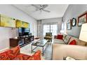 Cozy living room featuring a sofa, a glass coffee table, and a large television for entertainment at 269 Los Prados Dr # 1011, Safety Harbor, FL 34695
