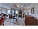 Spacious living room showcasing a fireplace, plush seating, and seamless flow to dining area at 2733 Via Cipriani # 830B, Clearwater, FL 33764