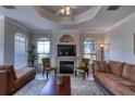 Comfortable living room with fireplace, plush seating, and arched windows for natural light at 2733 Via Cipriani # 830B, Clearwater, FL 33764