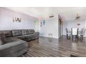 Spacious living room with a gray sofa, wood-look floors, and an open concept layout with view of dining area at 2901 26Th W St # 815, Bradenton, FL 34205