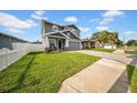 Well-maintained home features a lush green lawn and a driveway leading to the attached garage, adding to its charm at 3013 W Crest Ave, Tampa, FL 33614
