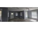 Bright living room with refinished hardwood floors, ceiling fans, and plenty of natural light at 305 E Adalee St, Tampa, FL 33603
