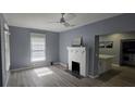 Living room featuring a fireplace, refinished floors, and a view into the kitchen at 305 E Adalee St, Tampa, FL 33603
