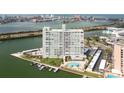 Aerial view showcasing the building's waterfront location, pool, and dock, offering scenic views at 31 Island Way # 502, Clearwater Beach, FL 33767