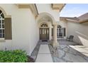 Inviting front porch and door with stone walkway at 5360 Karlsburg Pl, Palm Harbor, FL 34685