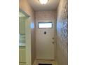 Entryway featuring a classic front door, decorative wallpaper, and tiled flooring at 5623 80Th N St # 314, St Petersburg, FL 33709