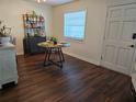 Airy dining room featuring dark flooring, modern furnishings, and natural light from the window at 5925 Terrace Park N Dr # 210, St Petersburg, FL 33709