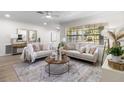 Bright and airy living room showcasing neutral decor, a large window, and stylish furnishings at 5998 8Th S St, St Petersburg, FL 33705