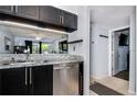 Well-appointed kitchen with stainless steel dishwasher, granite countertops, and an open design to the living area at 6932 Stones Throw N Cir # 7101, St Petersburg, FL 33710