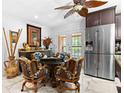 Charming dining area with unique ceiling fan, modern appliances, and patio access at 8105 N Grady Ave, Tampa, FL 33614