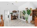 Bright and airy foyer with marble flooring, plants, and decorative accents at 8105 N Grady Ave, Tampa, FL 33614