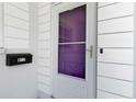 Close-up of a white front door with glass window, black mailbox, and house number for added curb appeal at 917 Pineview Ave, Clearwater, FL 33756