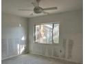 Bedroom under renovation featuring a window offering natural light and a ceiling fan for added comfort at 103 9Th St, Belleair Beach, FL 33786