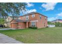 Side view of a two-story home with a well-maintained lawn under a blue sky at 10523 Boyette Creek Blvd, Riverview, FL 33569
