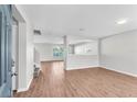 Spacious living room featuring hardwood floors, recessed lighting, and neutral paint at 10523 Boyette Creek Blvd, Riverview, FL 33569