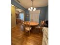 The dining room has a chandelier and seating for four, with a wood cabinet in the background at 1448 Highland Ridge Cir, Brandon, FL 33510