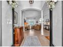 Elegant foyer with tile flooring, columns, and an open view of the living area at 15206 Merlinpark Pl, Lithia, FL 33547