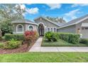Inviting home exterior featuring lush landscaping and a welcoming walkway at 15206 Merlinpark Pl, Lithia, FL 33547