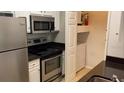 Well-equipped kitchen with stainless steel appliances and a convenient laundry area for easy living at 1910 E Palm Ave # 11322, Tampa, FL 33605