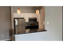 Efficient kitchen with stainless steel appliances, white cabinets, and breakfast bar for modern living at 1910 E Palm Ave # 11322, Tampa, FL 33605