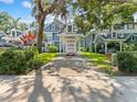 Street view of blue-sided townhouse with carport and U-Box moving container at 290 Winchester Way, Palm Harbor, FL 34684