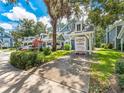 Street view of blue-sided townhouse with carport and U-Box moving container at 290 Winchester Way, Palm Harbor, FL 34684