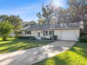 Inviting single-story home featuring an attached garage and long private driveway at 31096 Inwood Cir, Brooksville, FL 34602