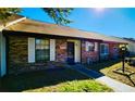 Cozy brick townhouse with white shutters and a dark-colored front door, offering a welcoming entrance at 35140 Whispering Oaks Blvd, Dade City, FL 33523