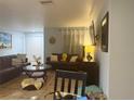 Spacious living room featuring comfortable seating, tile flooring, and ample natural light at 402 Evergreen Dr, Oldsmar, FL 34677