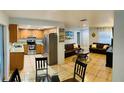 Open concept living space with a kitchen, dining area and living room with comfortable seating at 402 Evergreen Dr, Oldsmar, FL 34677