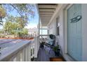 Charming front porch with a light blue door, chair, and plants at 408 Georgia Ave, Crystal Beach, FL 34681