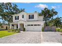 Inviting two-story home with brick paver driveway, lush green lawn, and a charming basketball hoop at 4114 W Neptune St, Tampa, FL 33629