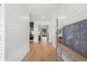 Bright hallway with hardwood floors and white shiplap walls leads to other rooms at 4114 W Neptune St, Tampa, FL 33629