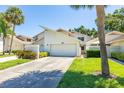 Inviting exterior showcasing a well-maintained facade, garage, and landscaped front yard of home number 45 at 498 Lakeview Dr # 45, Palm Harbor, FL 34683